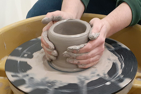 Potter Hands Making In Clay On Pottery Wheel. Potter Makes A