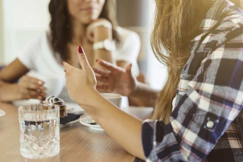 women talking at a table